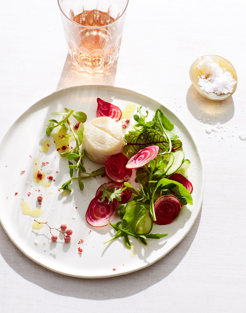 an aged goat cheese button with raw chioggia beet salad